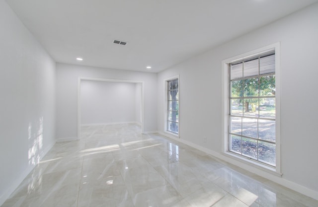 spare room featuring recessed lighting, marble finish floor, visible vents, and baseboards