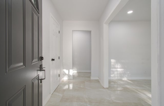 interior space with marble finish floor and baseboards