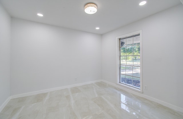 empty room featuring recessed lighting and baseboards