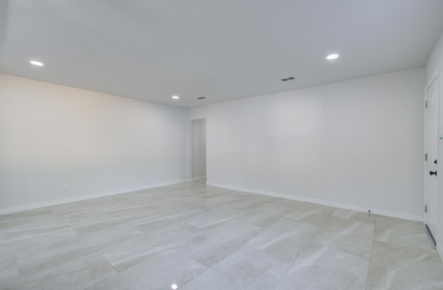 spare room featuring baseboards, visible vents, and recessed lighting