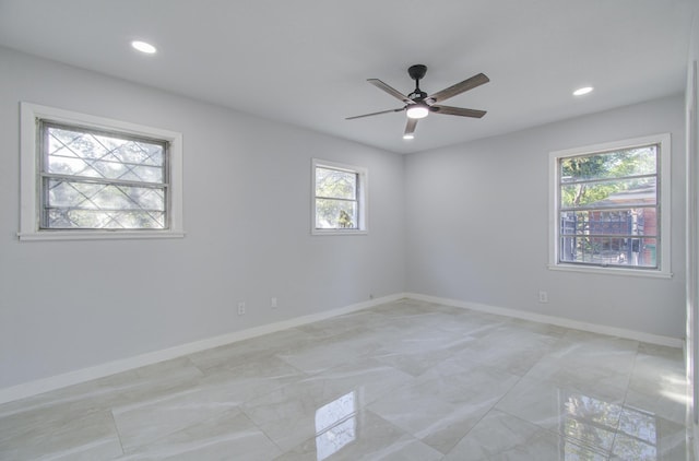 empty room with recessed lighting, ceiling fan, and baseboards