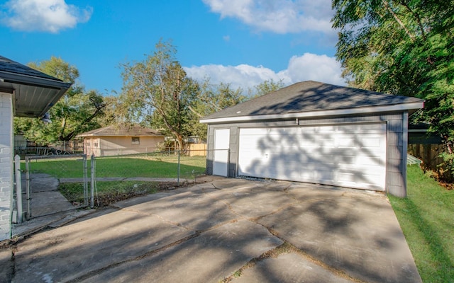 detached garage featuring fence