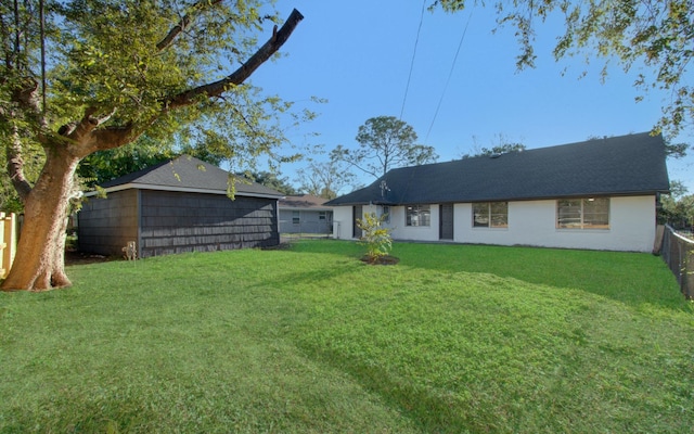 exterior space with fence and a lawn