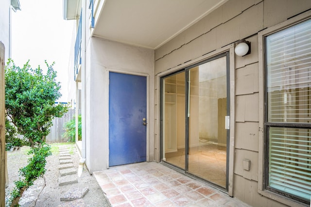 entrance to property with fence and a patio