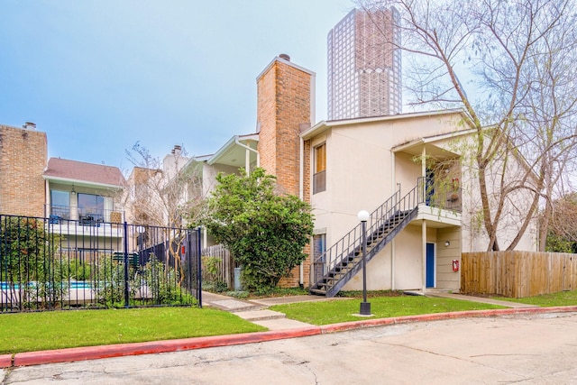 exterior space featuring stairway and fence