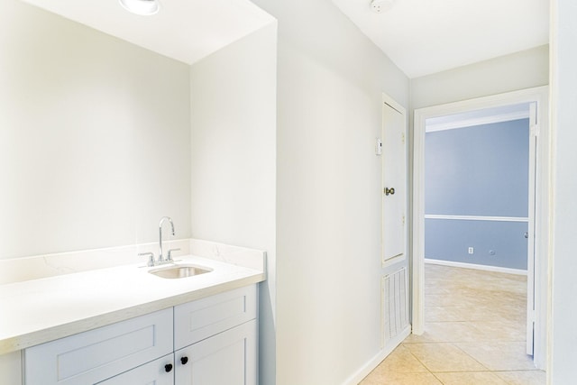 bathroom with tile patterned flooring, vanity, and baseboards