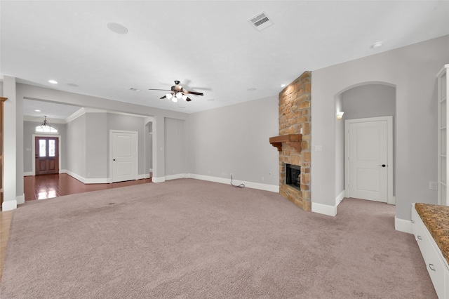 unfurnished living room featuring visible vents, baseboards, ceiling fan, carpet floors, and a fireplace