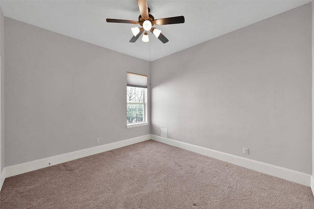 unfurnished room featuring carpet, ceiling fan, and baseboards