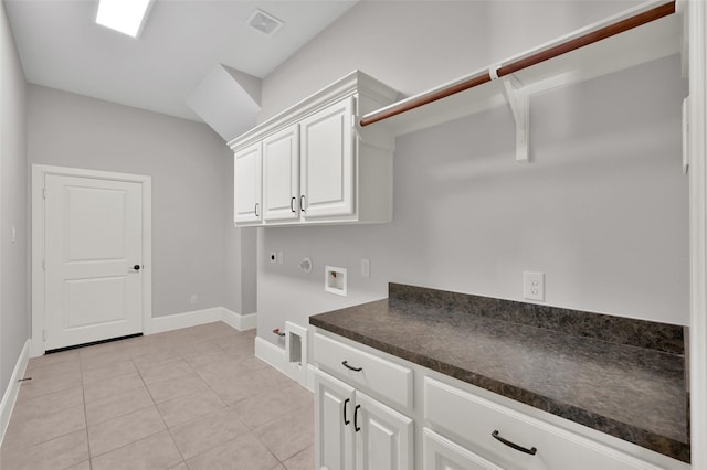 laundry area featuring washer hookup, light tile patterned floors, cabinet space, hookup for an electric dryer, and gas dryer hookup