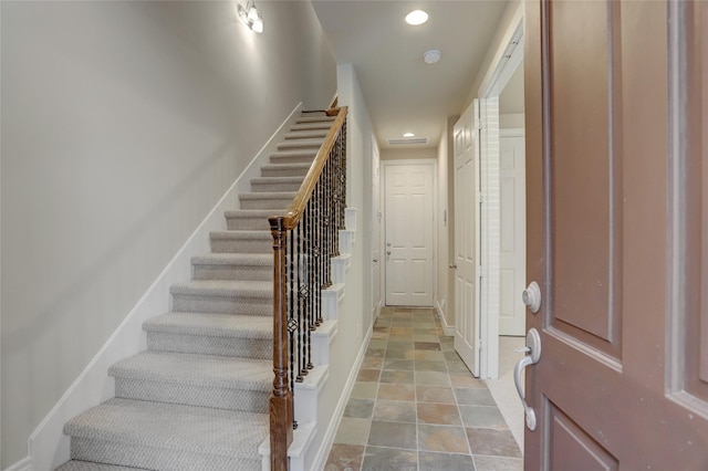 entryway with stairs, baseboards, and recessed lighting