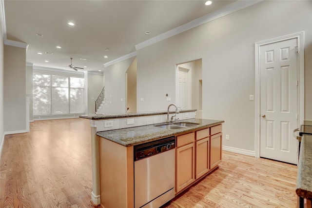 kitchen featuring a sink, light wood finished floors, open floor plan, and dishwasher