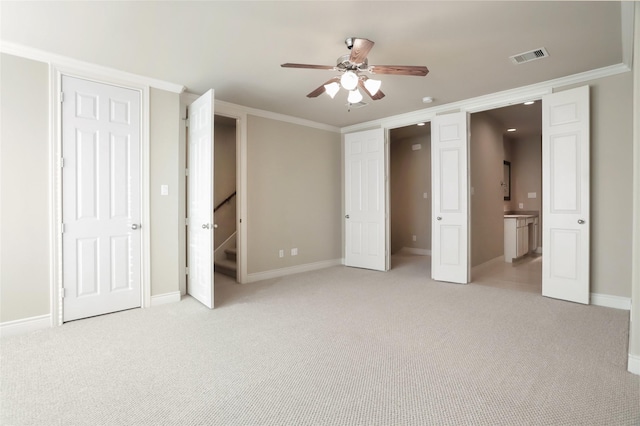 unfurnished bedroom featuring light carpet, baseboards, visible vents, and ornamental molding