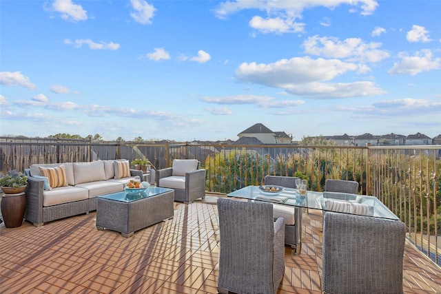 deck featuring outdoor dining space, fence, and an outdoor living space