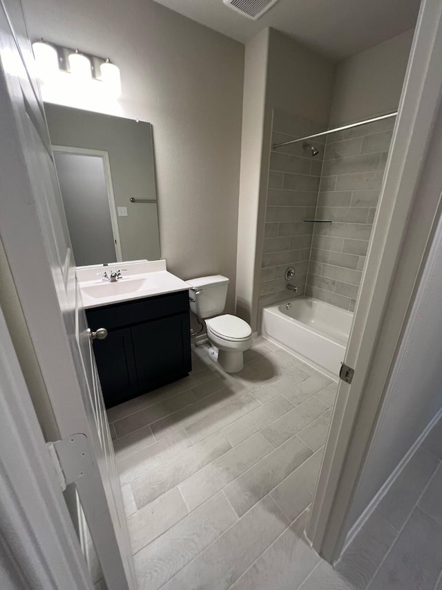 full bath featuring toilet, bathtub / shower combination, visible vents, and vanity