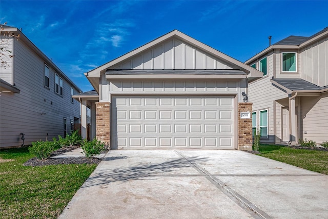 view of front of home featuring a garage, concrete driveway, brick siding, and board and batten siding