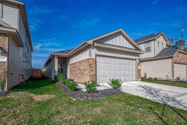 view of home's exterior with an attached garage, brick siding, a yard, concrete driveway, and board and batten siding