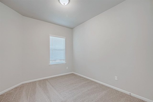 unfurnished room with carpet floors and baseboards