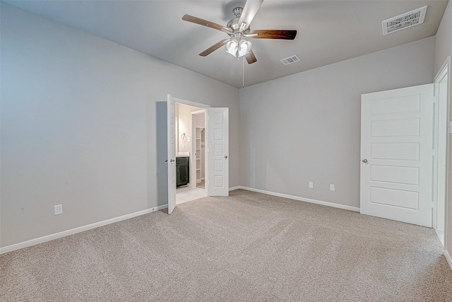 unfurnished bedroom with light carpet, baseboards, and visible vents