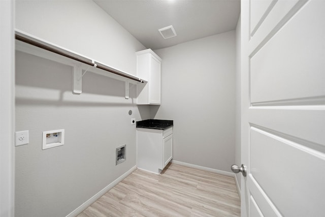 laundry room with hookup for a washing machine, cabinet space, visible vents, light wood-style floors, and hookup for an electric dryer