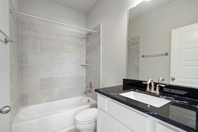 bathroom featuring  shower combination, a textured wall, vanity, and toilet