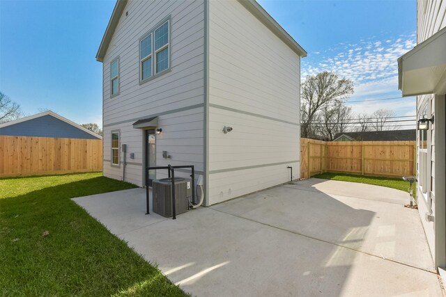 6835 New York St, Houston, TX 77021 - rear view of property featuring fence, a lawn, cooling unit, and a patio