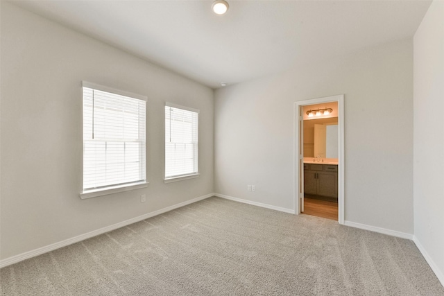 6835 New York St, Houston, TX 77021 - spare room featuring carpet flooring, a sink, and baseboards