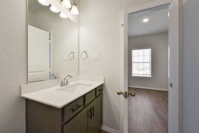 6835 New York St, Houston, TX 77021 - bathroom with wood finished floors, vanity, and baseboards
