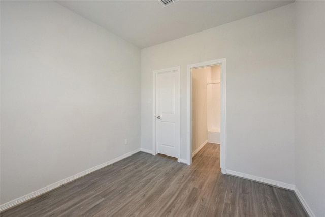 6835 New York St, Houston, TX 77021 - unfurnished bedroom with baseboards and dark wood finished floors