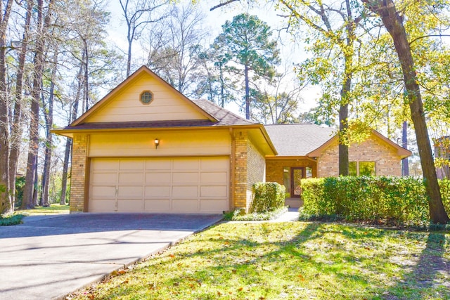 view of front facade featuring a garage, brick siding, a shingled roof, driveway, and a front lawn