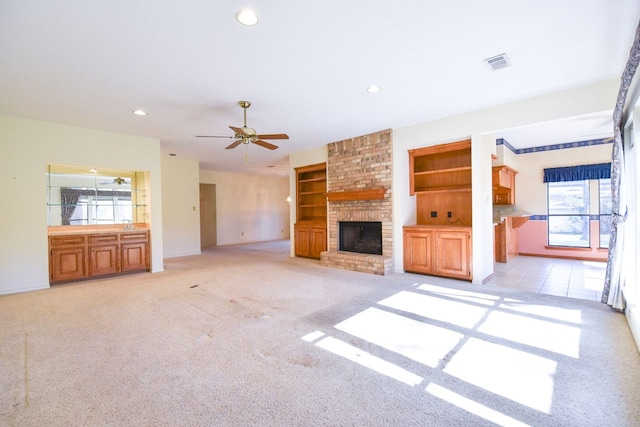 unfurnished living room featuring light carpet, a fireplace, visible vents, and recessed lighting