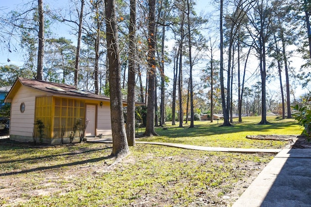 view of yard with an outbuilding and a greenhouse