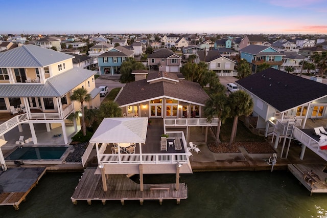 birds eye view of property with a water view and a residential view