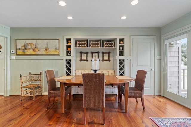 dining area featuring built in shelves, recessed lighting, and wood-type flooring