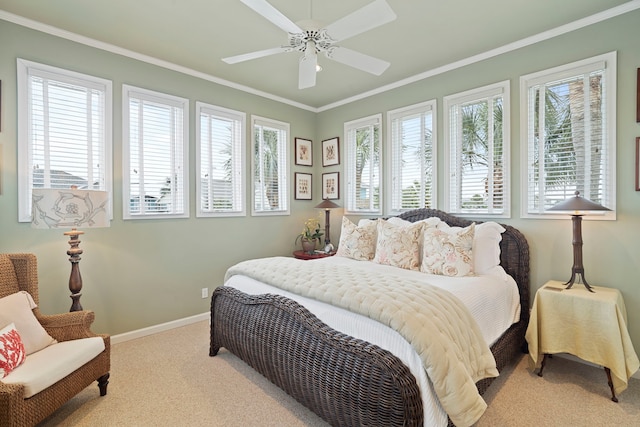 bedroom with baseboards, carpet, a ceiling fan, and crown molding