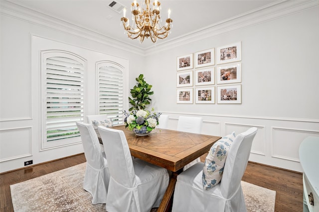 dining space featuring an inviting chandelier, a decorative wall, visible vents, and dark wood-style flooring