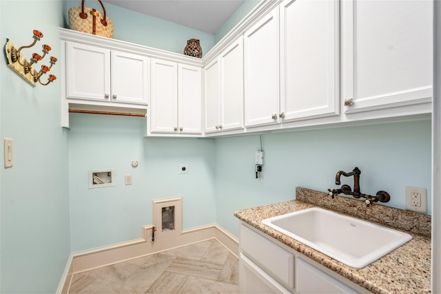 clothes washing area with hookup for a washing machine, cabinet space, electric dryer hookup, a sink, and hookup for a gas dryer