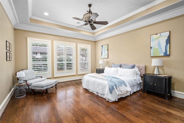 bedroom with multiple windows, baseboards, and wood finished floors