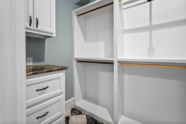 spacious closet featuring marble finish floor