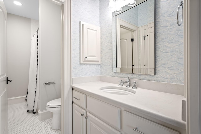 bathroom with vanity, toilet, tile patterned flooring, and wallpapered walls