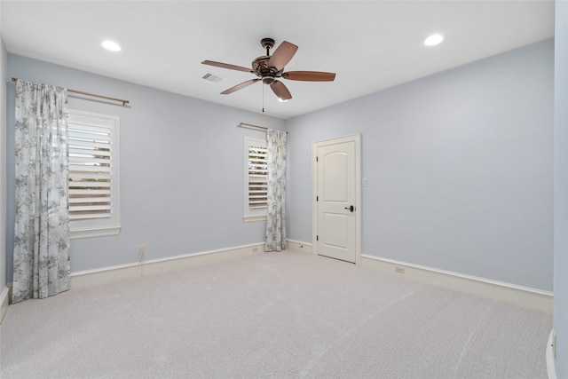 spare room featuring visible vents, recessed lighting, carpet flooring, baseboards, and ceiling fan