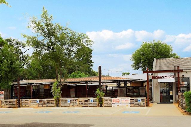 view of building exterior with uncovered parking