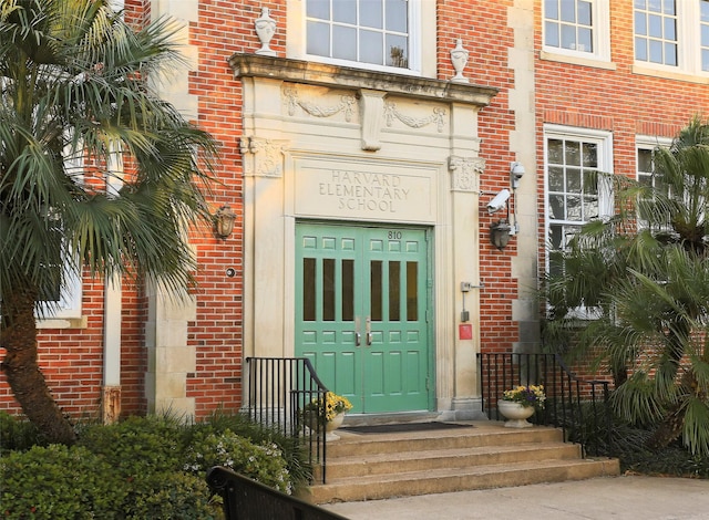 doorway to property featuring brick siding