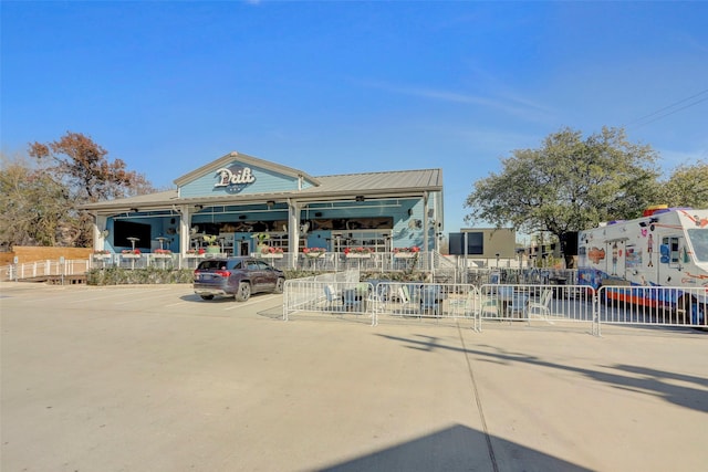 exterior space featuring fence and uncovered parking