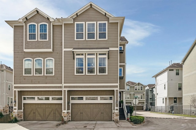 multi unit property featuring a garage and driveway