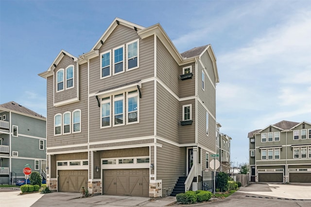 townhome / multi-family property featuring concrete driveway and a garage