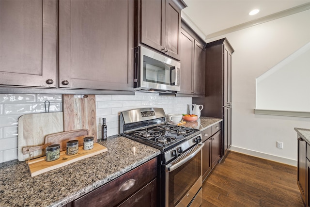 kitchen featuring stone counters, stainless steel appliances, tasteful backsplash, and dark brown cabinetry