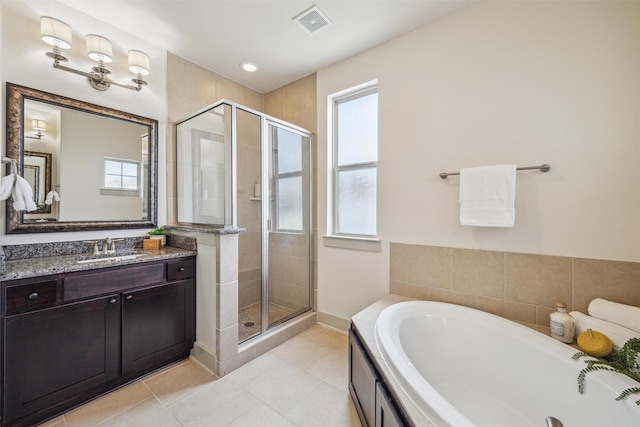 bathroom with a shower stall, a bath, a healthy amount of sunlight, and visible vents