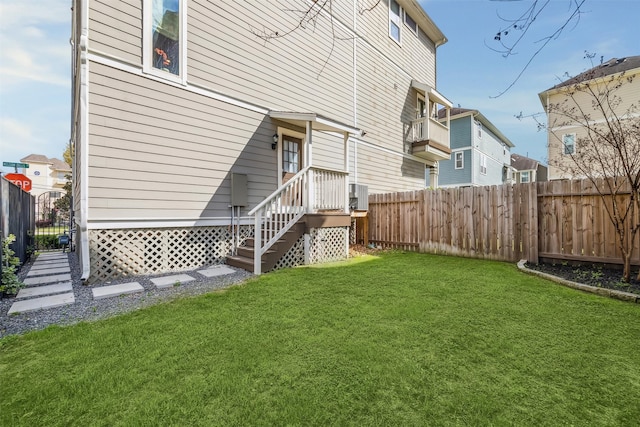 rear view of property with a yard and fence