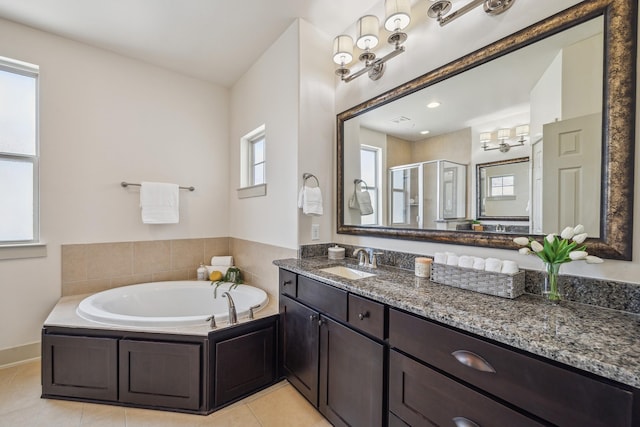 bathroom with vanity, a garden tub, plenty of natural light, and a stall shower