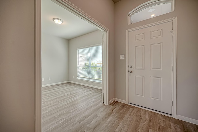 entrance foyer with light wood-type flooring and baseboards